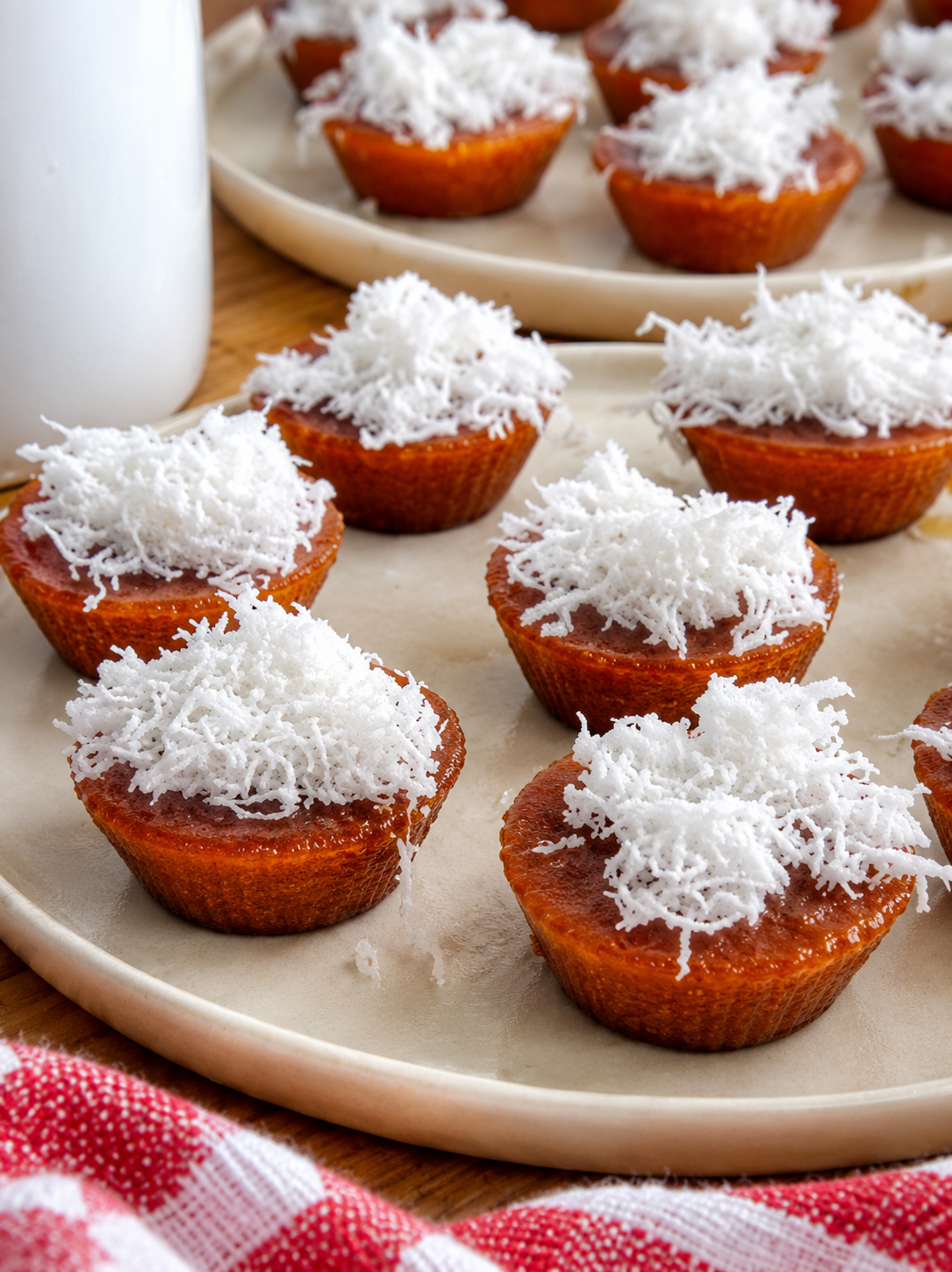 Traditional Filipino kutsinta rice cakes topped with freshly grated coconut on a serving plate.