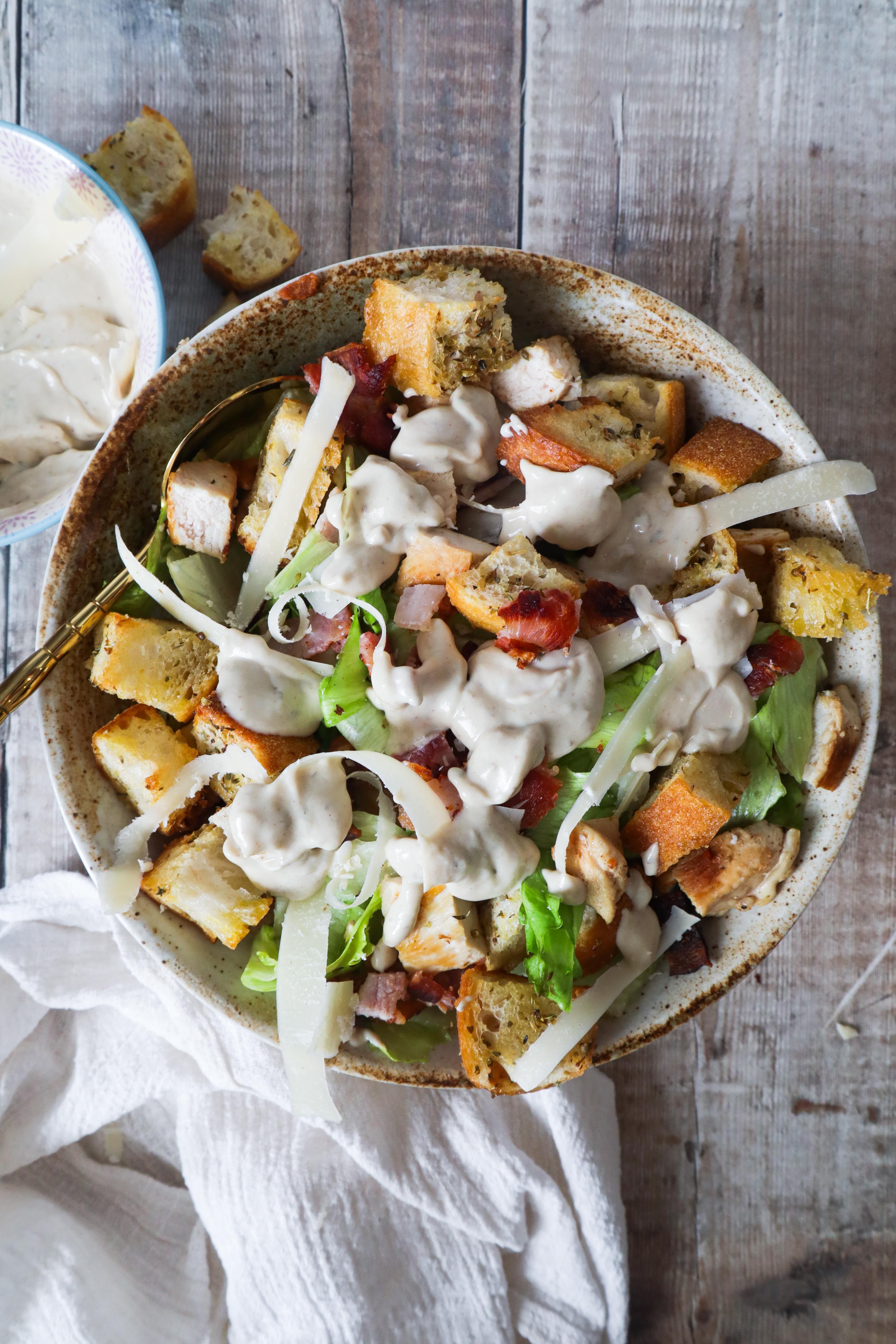 Easy Caesar Salad Recipe with crisp romaine lettuce, Parmesan cheese, crunchy croutons, and creamy dressing.