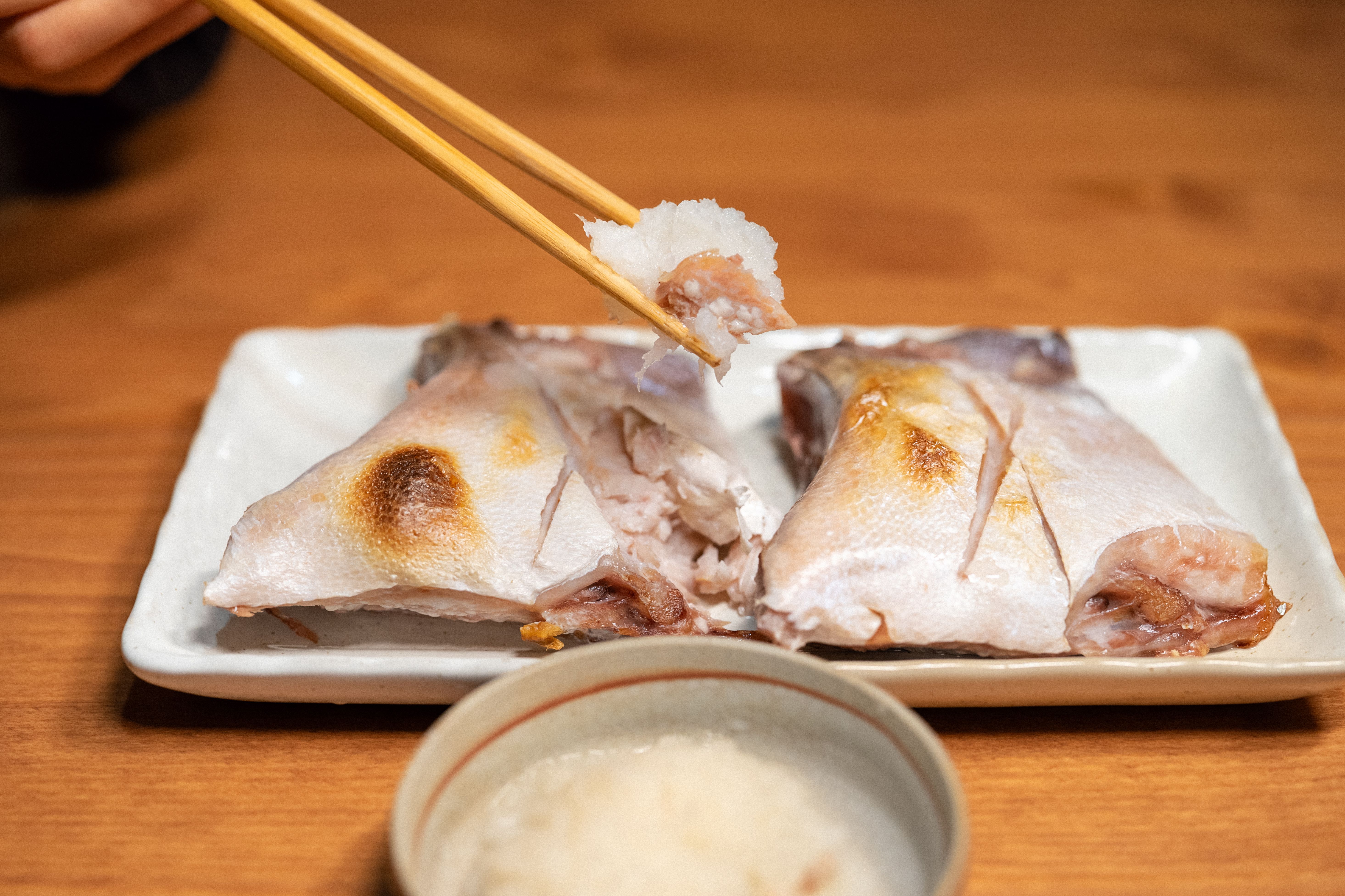 Broiled hamachi kama with blistered golden skin served with grated daikon, lemon and citrus ponzu.