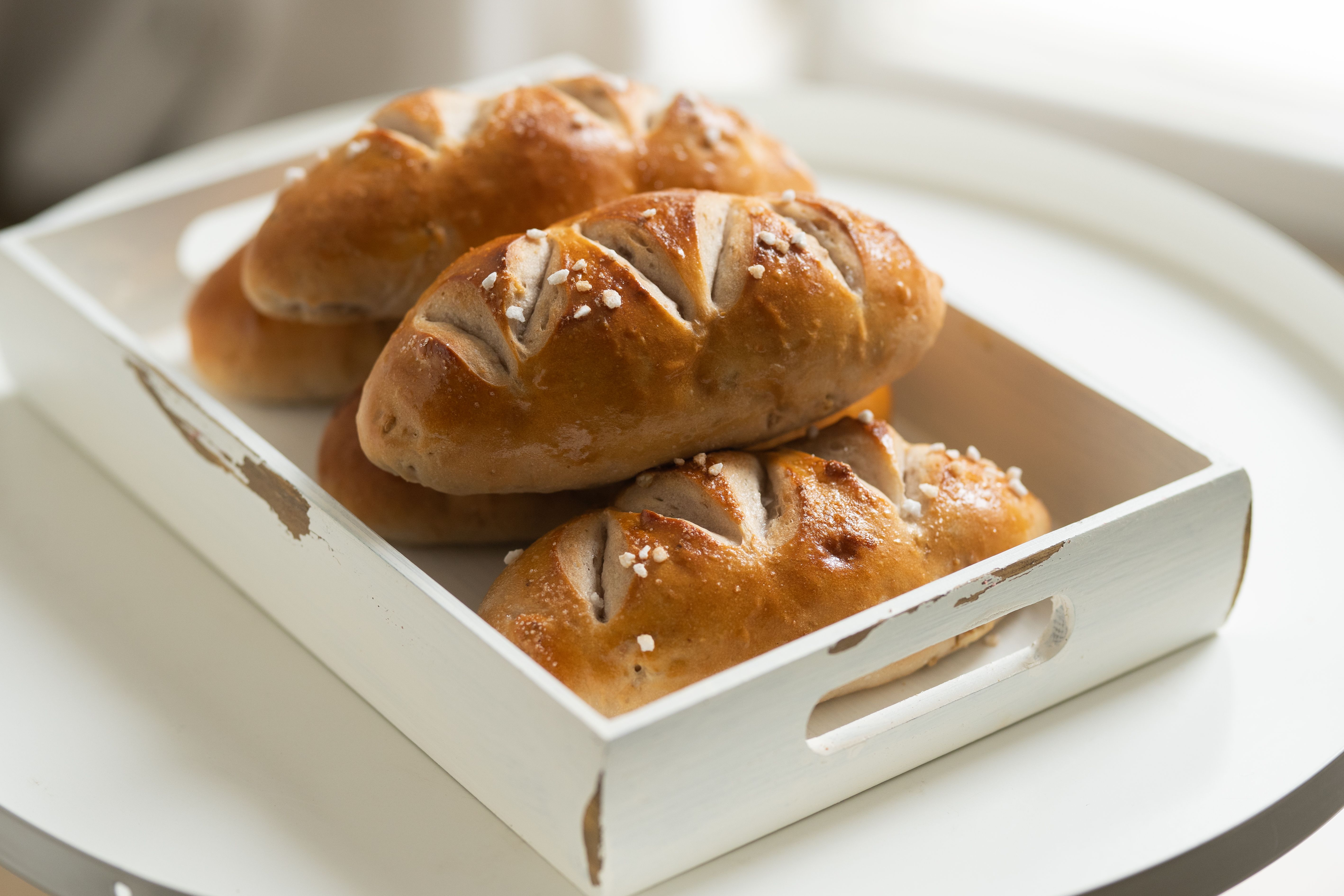 Golden Japanese salt bread rolls with flaky sea salt, crisp buttery bottoms and soft airy centres.
