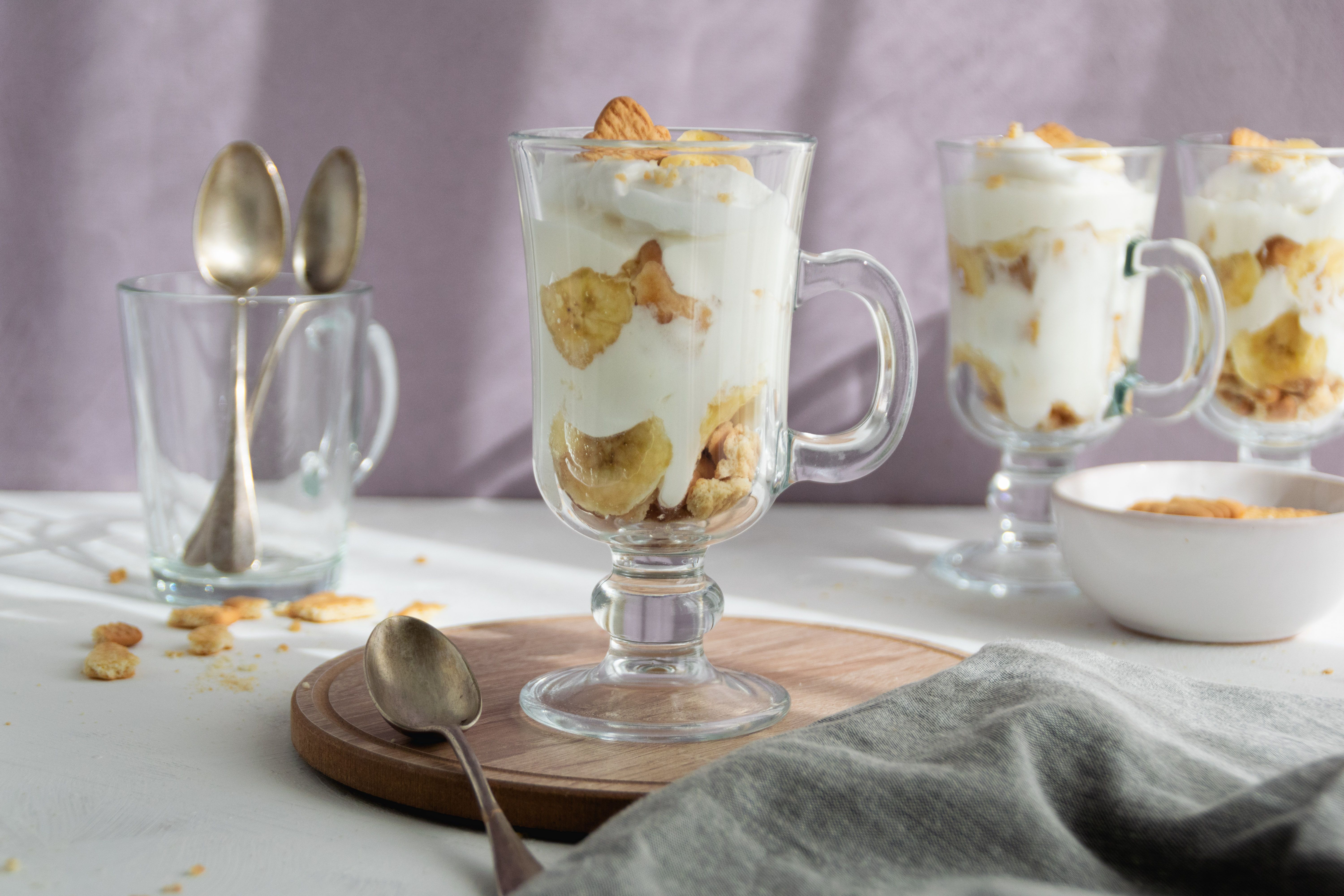 Southern cream cheese banana pudding layered with fresh bananas, homemade vanilla custard, whipped cream and butter shortbread cookies.