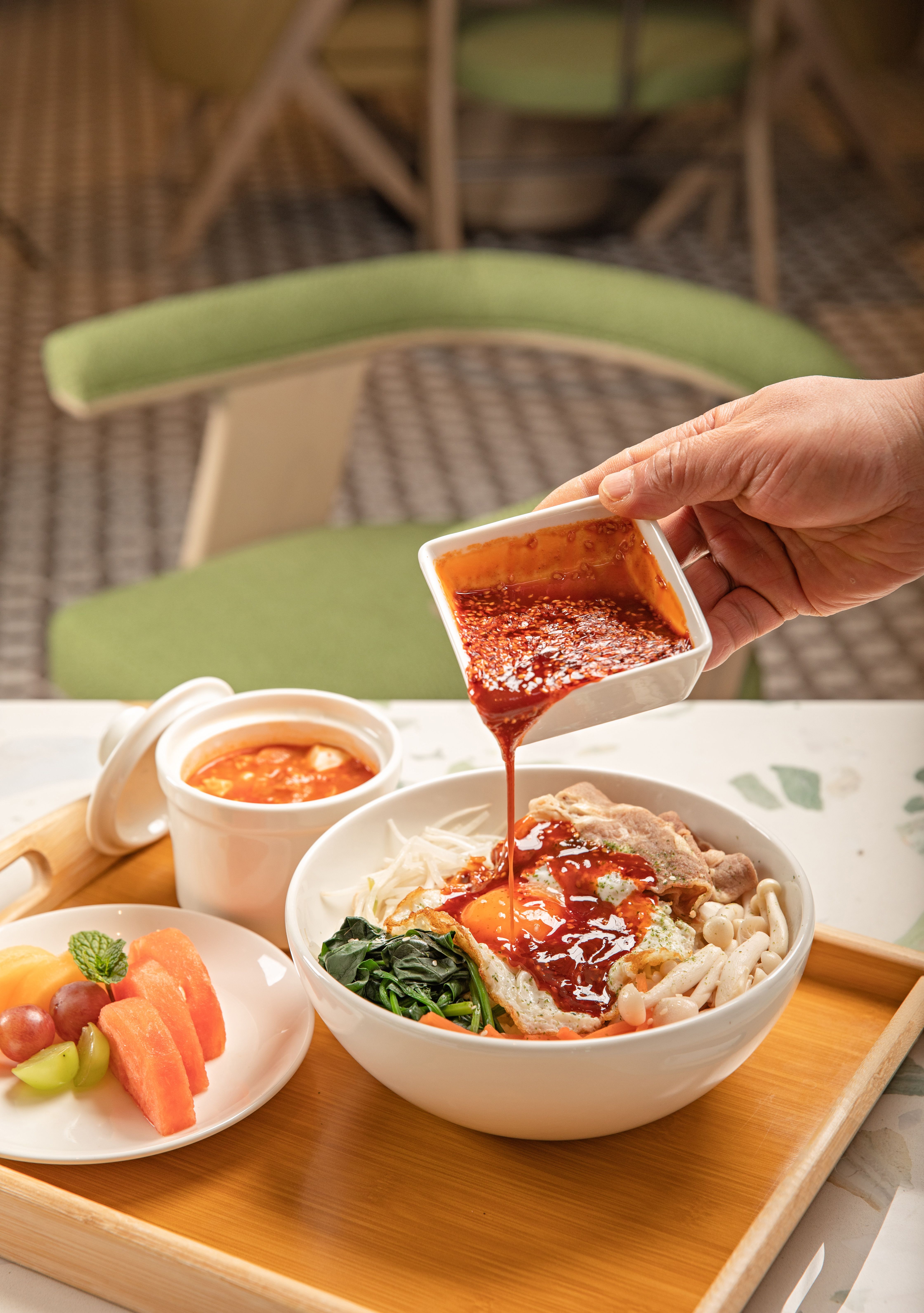 Japanese sukiyaki sauce in a small ceramic bowl beside soy sauce, mirin, sake and brown sugar.