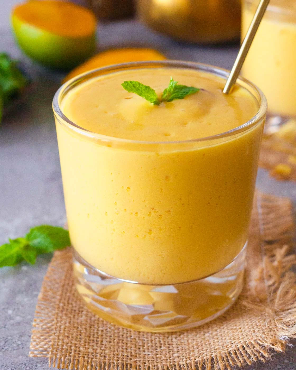Thick mango lassi topped with cream and served chilled