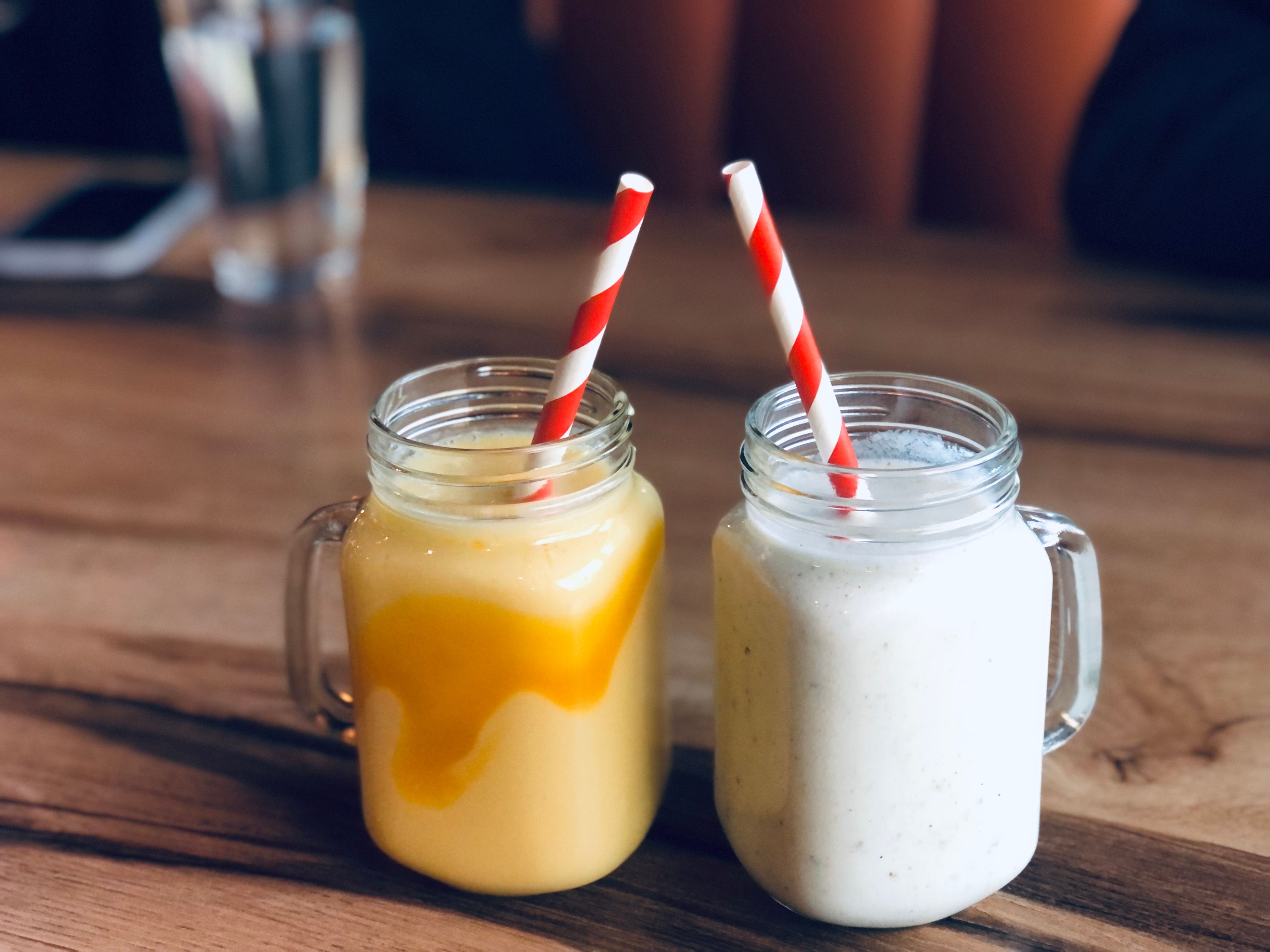 Three glasses of sweet, salted, and mango lassi served chilled with cardamom, cumin, mint, and pistachios