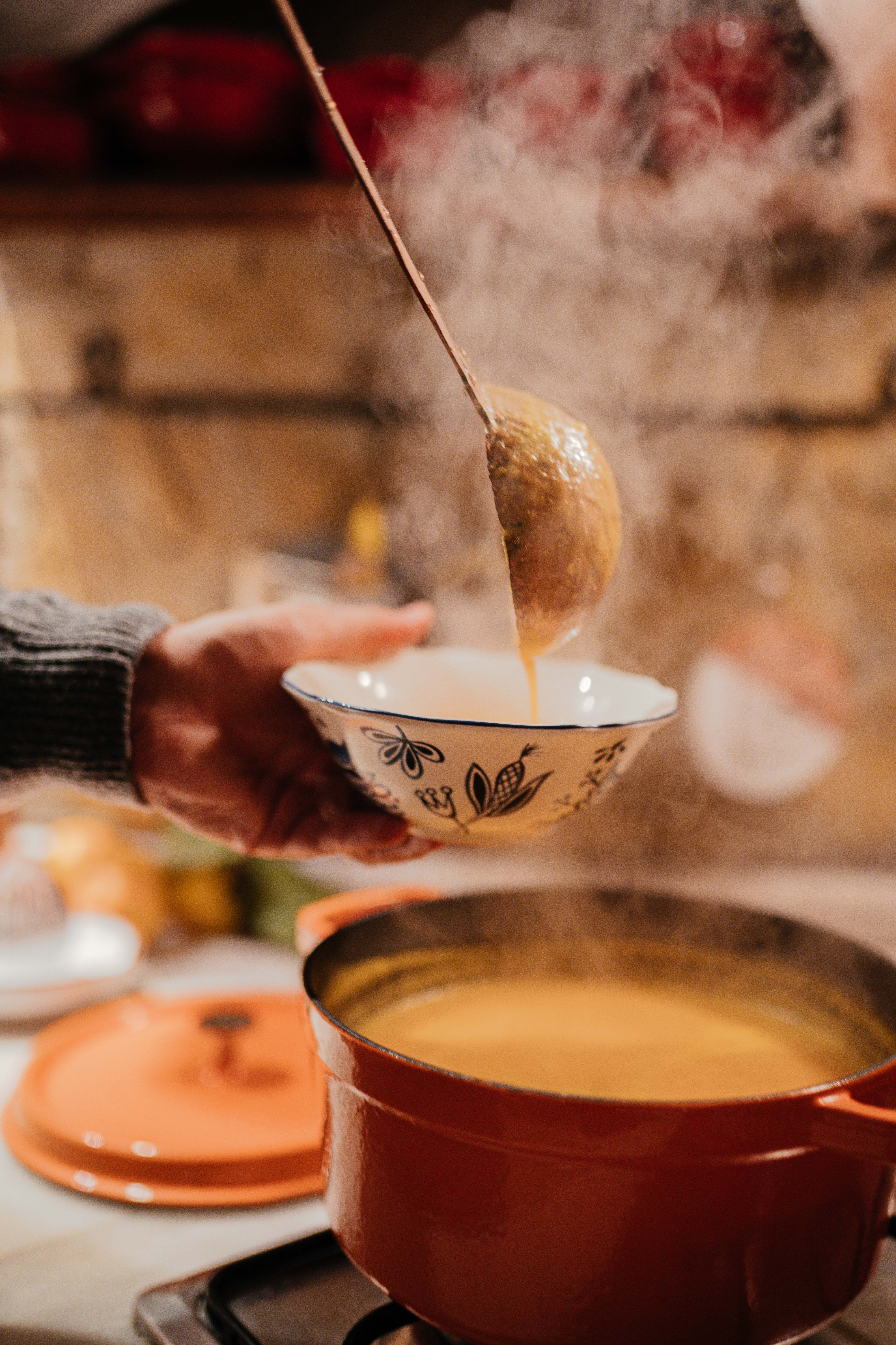 A cozy winter table filled with nihari, soup, sarson ka saag, fresh bread, gajar ka halwa, and hot chai