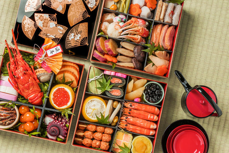 A Japanese cuisine cookbook cover with rice bowls, skewers, tofu dishes, sweets, and soothing tea-inspired elements.