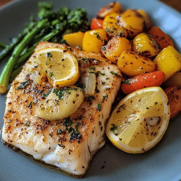 Golden baked cod fillets topped with crispy garlic herb crumbs and lemon wedges.