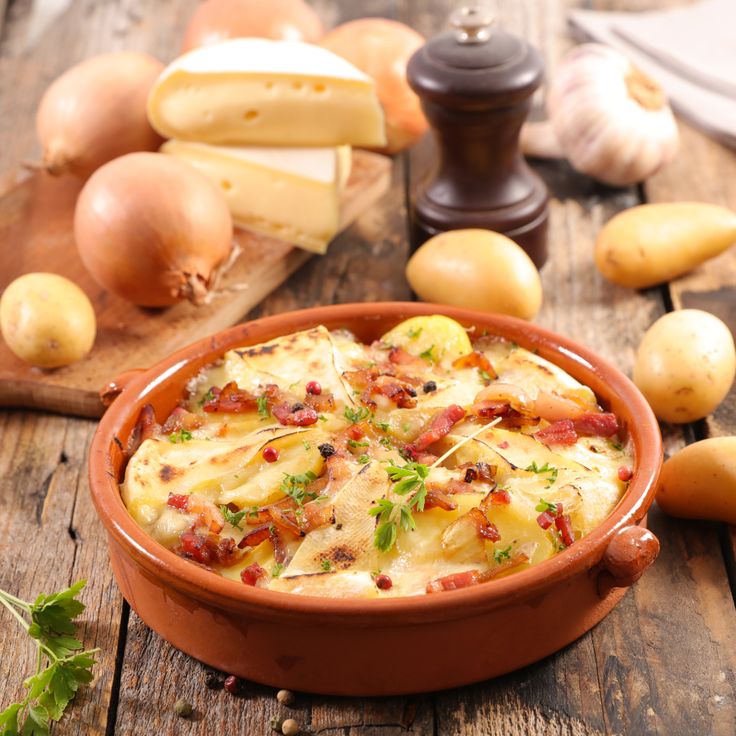 Baked tartiflette with melted cheese, potatoes, and bacon.