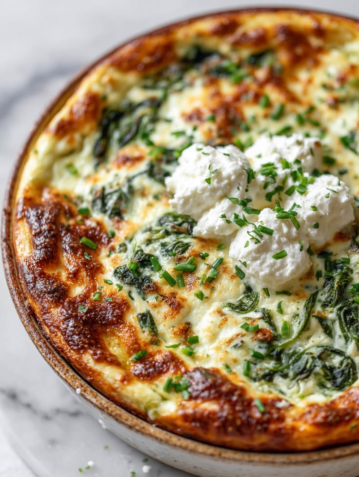 Fluffy green spinach soufflé baked until golden and puffed.