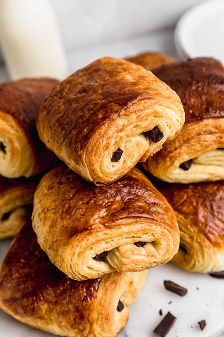 Golden flaky pain au chocolat with melted chocolate inside.