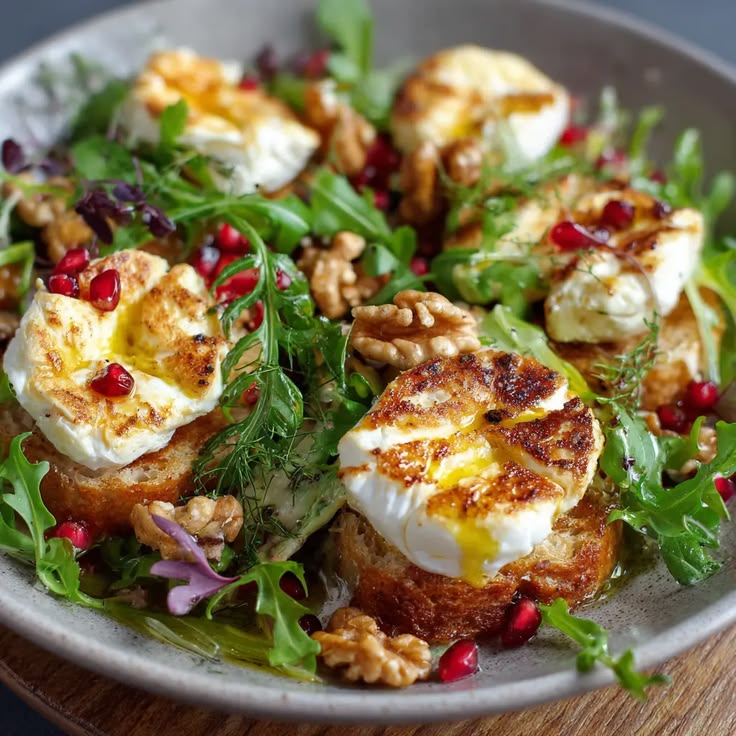 Warm goat cheese salad with toasted bread and walnuts.
