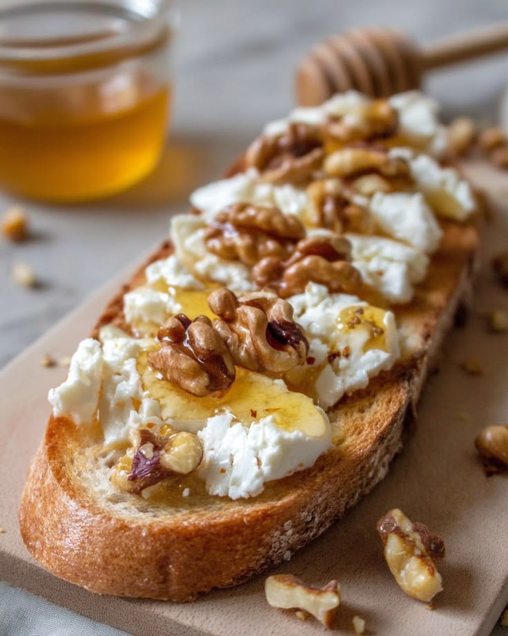 French tartine with goat cheese, honey and walnuts on toasted bread