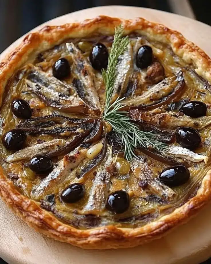 French Pissaladière onion tart topped with olives and anchovies.