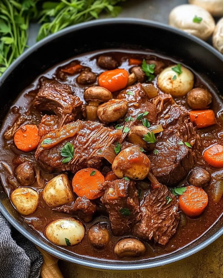 rich french beef bourguignon stew with tender beef and mushrooms in dark sauce