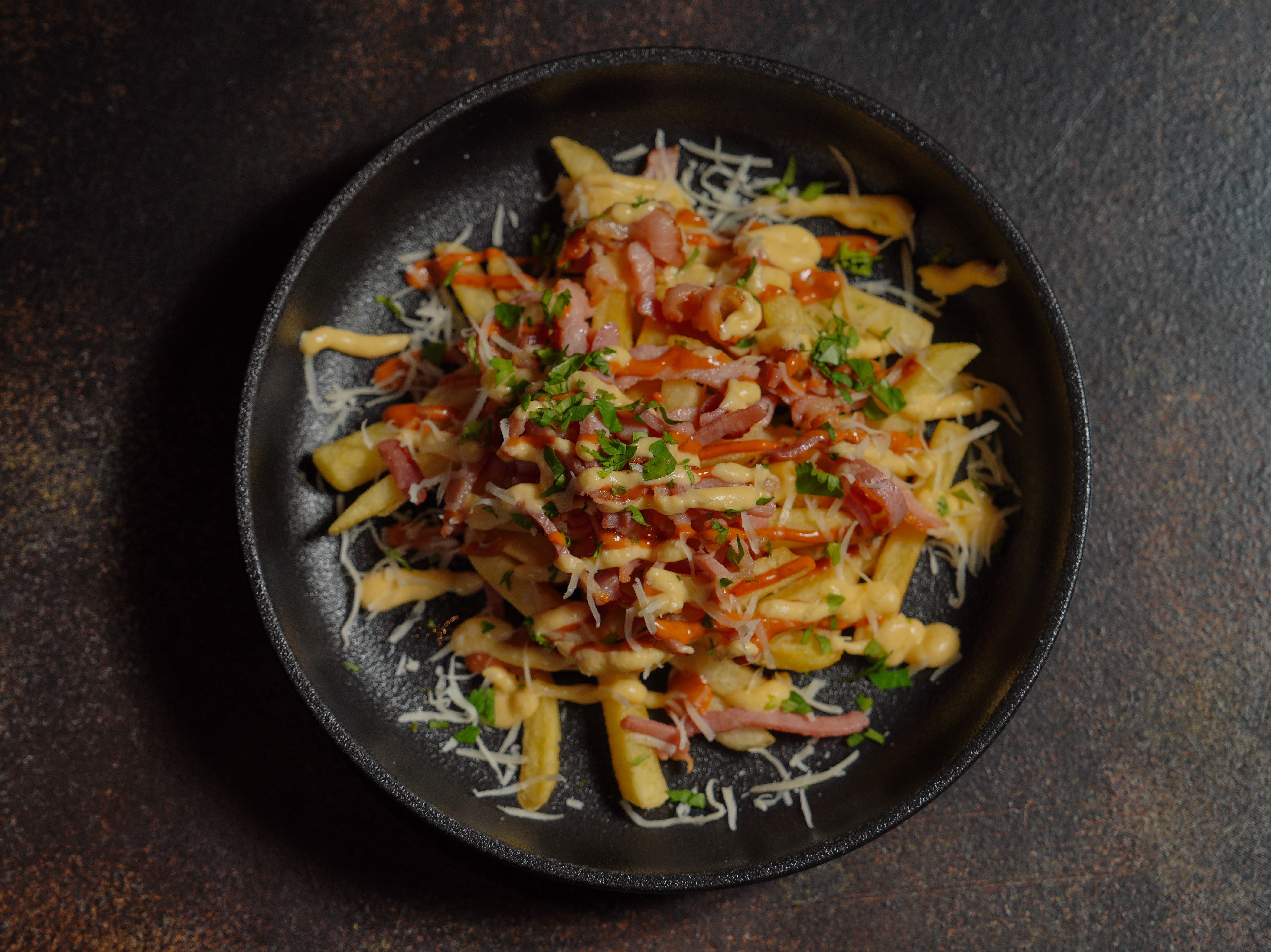 Authentic Canadian poutine with golden French fries, white cheddar cheese curds and rich brown gravy.