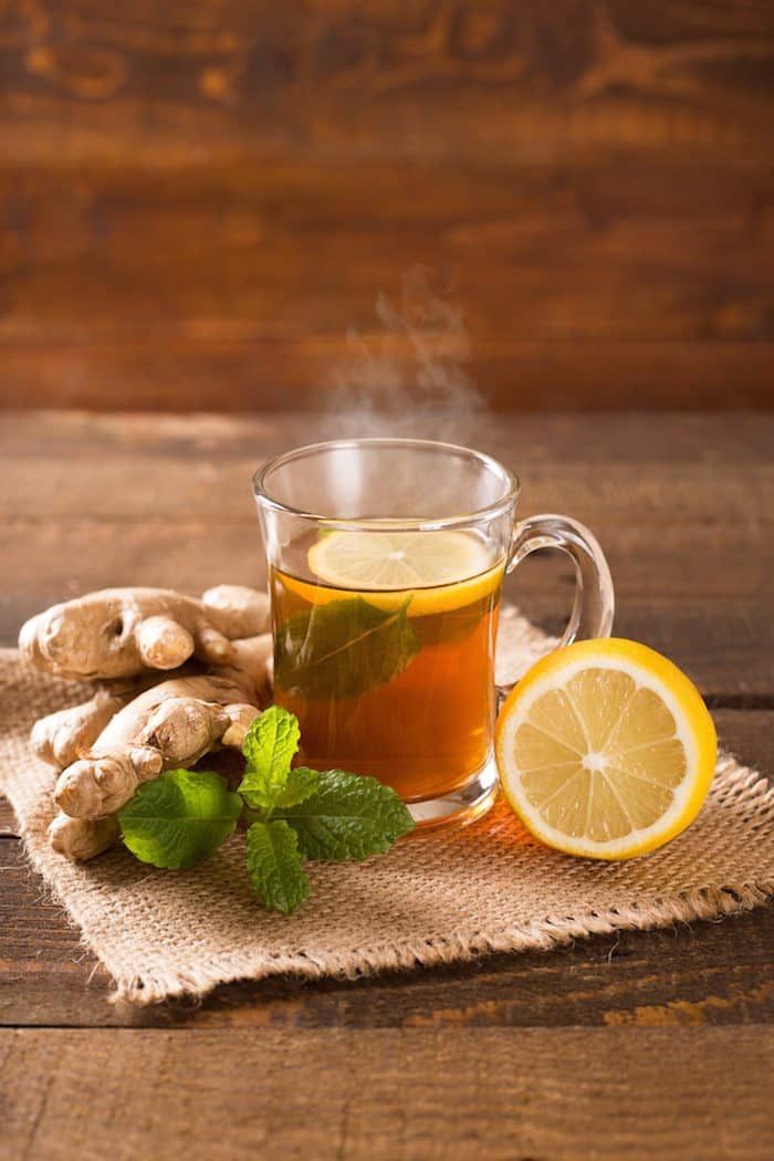 French herbal tisane tea served warm with herbs and lemon.